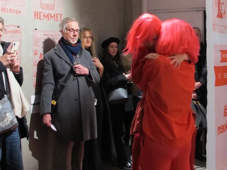 Vernissage of Home is where her horror is, artist with textile posters